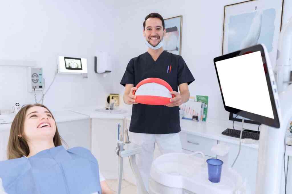 Dentist showing a dental model to a patient