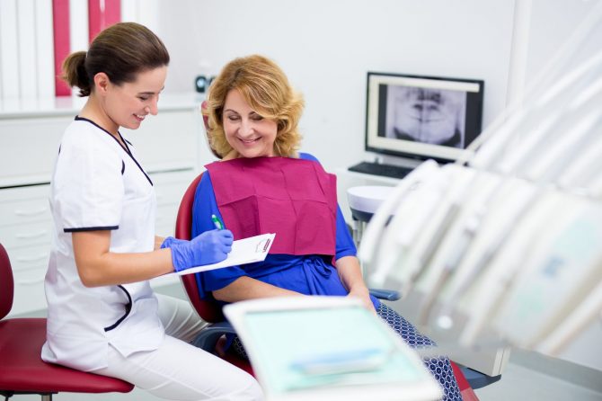 bigstock-Dentist-With-Clipboard-Talking-332382196-670x446 Emergency visits dentist Hartland