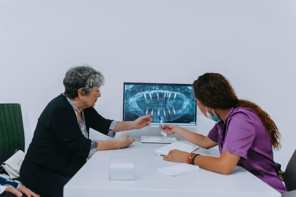 Dental professional reviewing dental implant X-rays
