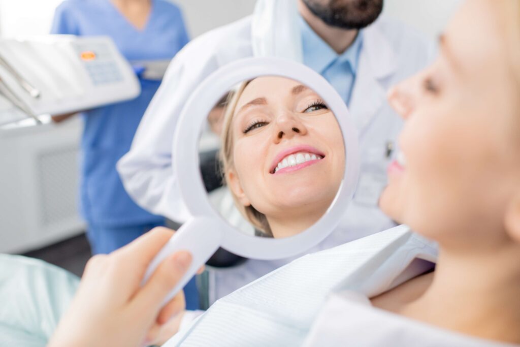 Patient viewing her smile in a mirror.